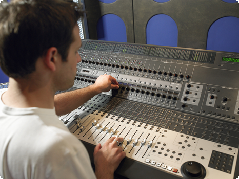 Man Training on Sound Board in Studio